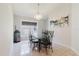 Bright dining room with glass table, chandelier, and a large window providing natural light at 7239 Sharpsburg Blvd, New Port Richey, FL 34653