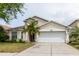 Well-maintained home boasts a two-car garage, manicured lawn, and beautiful shade tree at 7239 Sharpsburg Blvd, New Port Richey, FL 34653