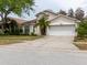 Lovely single-story house with a two-car garage, tidy lawn, and inviting curb appeal at 7239 Sharpsburg Blvd, New Port Richey, FL 34653