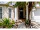 Inviting entryway with decorative columns, lush landscaping, and a well-lit walkway at 7239 Sharpsburg Blvd, New Port Richey, FL 34653