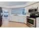 Kitchen featuring stainless steel appliances and view to dining area at 7239 Sharpsburg Blvd, New Port Richey, FL 34653