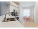 Bright kitchen with stainless steel appliances and breakfast nook with orange chairs at 7239 Sharpsburg Blvd, New Port Richey, FL 34653