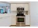 White kitchen with stainless steel appliances and view to the breakfast area at 7239 Sharpsburg Blvd, New Port Richey, FL 34653
