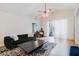 Bright living room featuring a modern rug, vaulted ceilings, and a decorative ceiling fan at 7239 Sharpsburg Blvd, New Port Richey, FL 34653