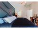 This main bedroom has a navy accent wall and a large window that provides natural lighting at 7239 Sharpsburg Blvd, New Port Richey, FL 34653