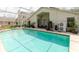Backyard oasis with a screened pool, patio area, and well-maintained landscaping at 7239 Sharpsburg Blvd, New Port Richey, FL 34653