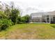An expansive yard leads to a screened-in pool and patio connected to the residence at 7239 Sharpsburg Blvd, New Port Richey, FL 34653