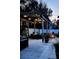 Backyard patio with cozy fire pit, pergola with string lights, and seating for outdoor gatherings at 8434 Hazelton St, Spring Hill, FL 34608