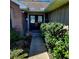 Inviting front entrance featuring double doors with decorative glass and lush landscaping at 8434 Hazelton St, Spring Hill, FL 34608