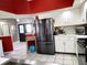 Spacious kitchen featuring stainless steel appliances, white cabinets, and neutral countertops at 8434 Hazelton St, Spring Hill, FL 34608