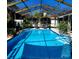 Backyard pool with a screened enclosure and a patio deck at 8434 Hazelton St, Spring Hill, FL 34608