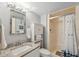 Bright bathroom featuring a vanity with granite countertop, and a shower/tub combo at 9 Forbes Pl # 512, Dunedin, FL 34698