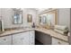 Elegant bathroom with granite countertop, double vanity, and decorative mirrors at 9 Forbes Pl # 512, Dunedin, FL 34698