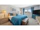 Comfortable bedroom with blue accents, natural light, and a view of the community at 9 Forbes Pl # 512, Dunedin, FL 34698