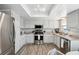 Bright kitchen featuring white cabinets, stainless steel appliances, and modern countertops at 9 Forbes Pl # 512, Dunedin, FL 34698