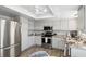 Updated kitchen with white cabinetry, stainless steel appliances, and a view of the water at 9 Forbes Pl # 512, Dunedin, FL 34698