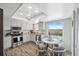 Cozy kitchen with white cabinetry, stainless steel appliances, and a breakfast nook with a view at 9 Forbes Pl # 512, Dunedin, FL 34698
