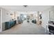 Bright, carpeted living room with sliding glass doors leading to a balcony and water views at 9 Forbes Pl # 512, Dunedin, FL 34698