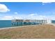 Community pier that extends into the ocean, with benches and railings at 9 Forbes Pl # 512, Dunedin, FL 34698