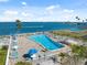 A beautiful community pool with lounge chairs overlooks the stunning bay at 9 Forbes Pl # 512, Dunedin, FL 34698