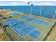 Aerial view of well-maintained community tennis courts with a water view at 9 Forbes Pl # 512, Dunedin, FL 34698