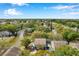 Aerial view of waterfront townhomes, surrounded by mature trees and a lake at 9046 Lake Place Ln # 9046, Tampa, FL 33634