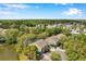Aerial view of community featuring lush trees, townhomes, and lake views at 9046 Lake Place Ln # 9046, Tampa, FL 33634
