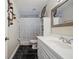 Well-lit bathroom featuring a vanity, white cabinets, and a shower with a white curtain at 9046 Lake Place Ln # 9046, Tampa, FL 33634