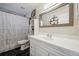 Bathroom featuring a large mirror, vanity with updated fixtures, and shower with patterned curtain at 9046 Lake Place Ln # 9046, Tampa, FL 33634