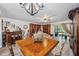 Elegant dining room and bar with a custom table, chandelier, and outdoor view at 9046 Lake Place Ln # 9046, Tampa, FL 33634