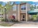 Charming two-story home with a covered carport, vibrant foliage, and manicured lawn at 9046 Lake Place Ln # 9046, Tampa, FL 33634
