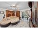 Spacious living room featuring a unique curved couch, decorative shelving, and sliding glass doors at 9046 Lake Place Ln # 9046, Tampa, FL 33634