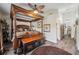 Luxurious main bedroom features a four-poster bed, wood floors, and a decorative ceiling fan at 9046 Lake Place Ln # 9046, Tampa, FL 33634