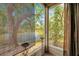 View from screened porch featuring a serene view of the lake and mature trees at 9046 Lake Place Ln # 9046, Tampa, FL 33634