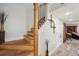 Well-lit staircase with wood railings and a decorative accent wall, leading to the upper level at 9046 Lake Place Ln # 9046, Tampa, FL 33634