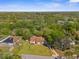 Aerial view of a home nestled among lush trees and greenery in a peaceful neighborhood at 9545 Sunshine Blvd, New Port Richey, FL 34654
