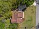 Aerial view shows the house with driveway and surrounding landscaping and nearby trees at 9545 Sunshine Blvd, New Port Richey, FL 34654
