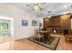 Spacious dining area featuring wood floors and a fireplace, adjacent to an open doorway at 9545 Sunshine Blvd, New Port Richey, FL 34654