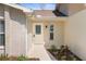 Inviting front porch with decorative door and adjacent landscaped garden area at 9545 Sunshine Blvd, New Port Richey, FL 34654