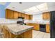 Functional kitchen with wood cabinets, modern appliances, and ample counter space at 9545 Sunshine Blvd, New Port Richey, FL 34654