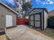View of backyard with a storage shed and side entry door into house at 10136 Highcrest Ln, New Port Richey, FL 34654