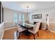 Well-lit dining room with modern chandelier, wainscoting, and window shutters at 10136 Highcrest Ln, New Port Richey, FL 34654