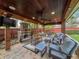 A spacious outdoor living area, complete with a fireplace, offers an inviting space for relaxation and entertainment at 10136 Highcrest Ln, New Port Richey, FL 34654
