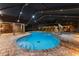 The beautifully lit pool area is perfect for relaxation and includes an outdoor kitchen and dining area at 10136 Highcrest Ln, New Port Richey, FL 34654