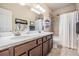Bathroom features a double sink vanity with a shower and tub combination at 10356 Fenceline Rd, New Port Richey, FL 34655