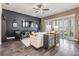 Bright living room featuring wood floors, shuttered windows, and stylish furnishings at 10356 Fenceline Rd, New Port Richey, FL 34655