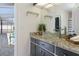 Bathroom featuring granite countertops, glass vessel sink, dark cabinetry, and decorative wall art at 1038 Greenturf Rd, Spring Hill, FL 34608