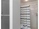 Bathroom with a combination shower and tub features a stylish shower curtain and linen closet at 1038 Greenturf Rd, Spring Hill, FL 34608
