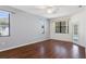 Bright bedroom featuring hardwood floors and a door with views to the outside at 1038 Greenturf Rd, Spring Hill, FL 34608