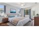 Staged main bedroom featuring a neutral color palette and bright natural light from the windows at 1038 Greenturf Rd, Spring Hill, FL 34608